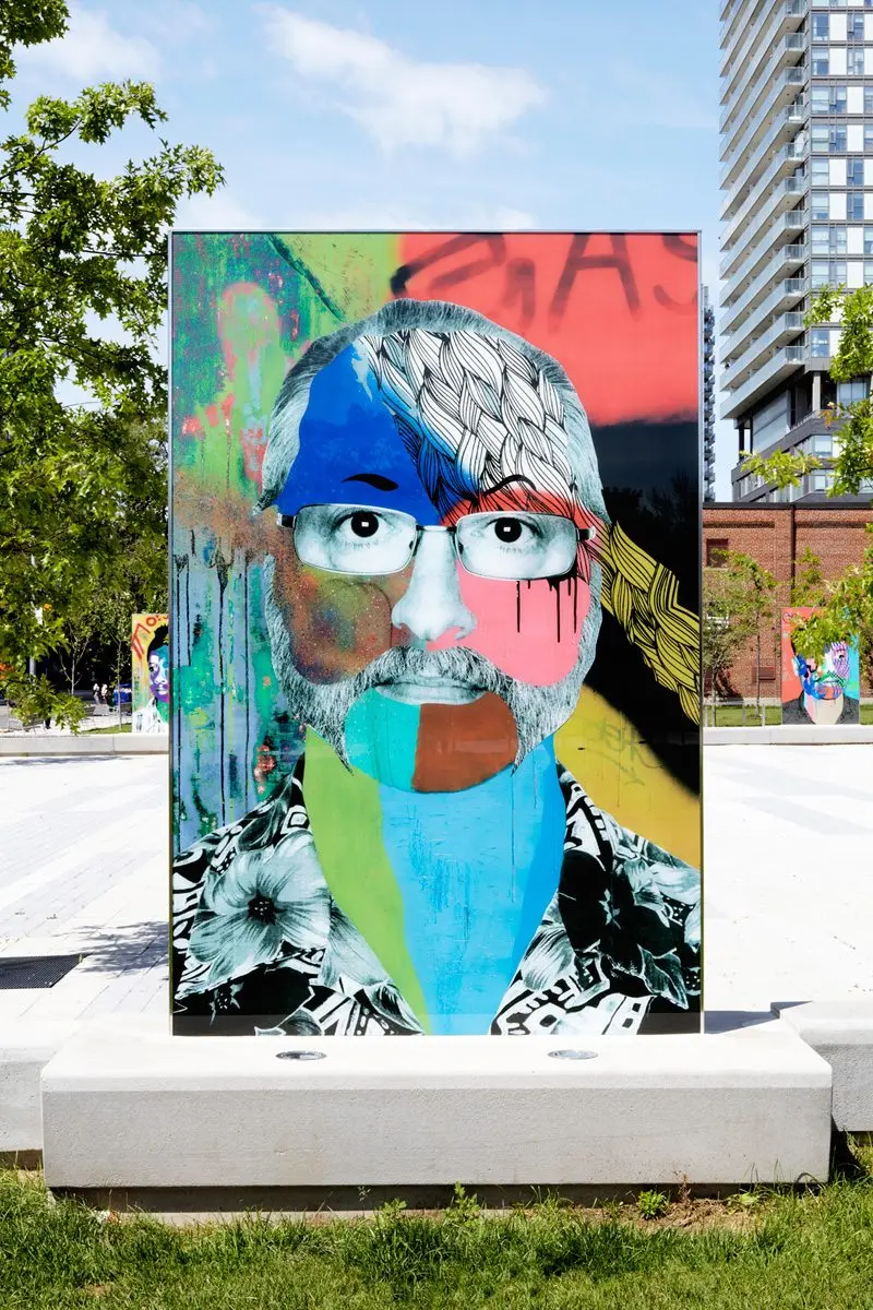 Painted portrait by Toronto artist Benny Bing, displayed outdoors in Regent Park